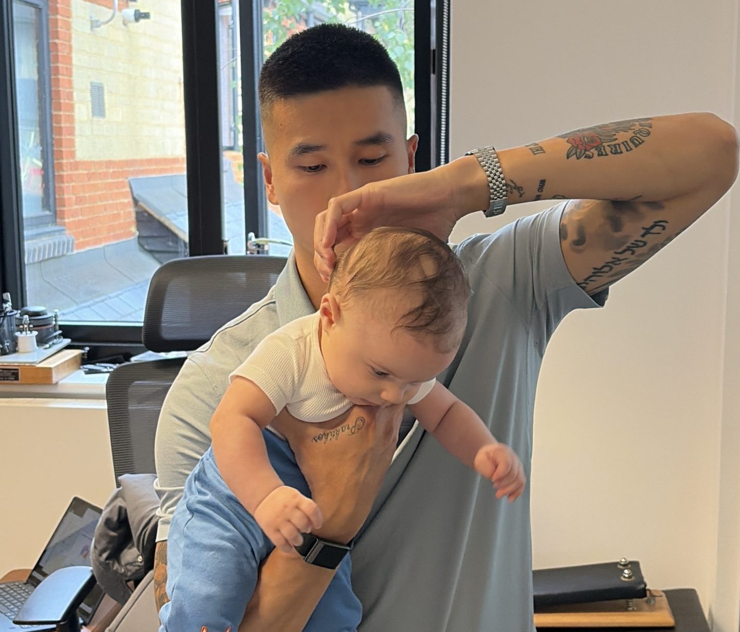 Chiropractor gently assessing and adjusting an infant's neuro-spinal system